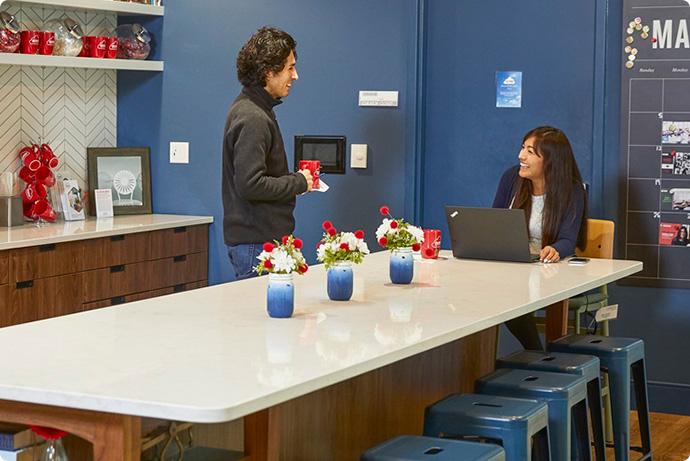 a man and a woman looking at a laptop