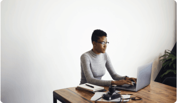 a man sitting at a desk with a laptop