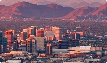 a city with tall buildings and mountains in the background