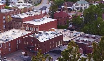 a group of buildings with trees in the front