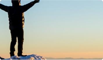 a person standing on a snowy hill