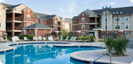 a swimming pool in front of a row of houses