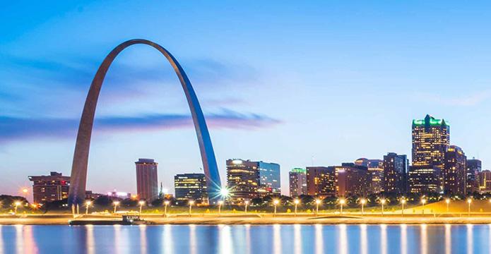 a large arch in front of Gateway Arch