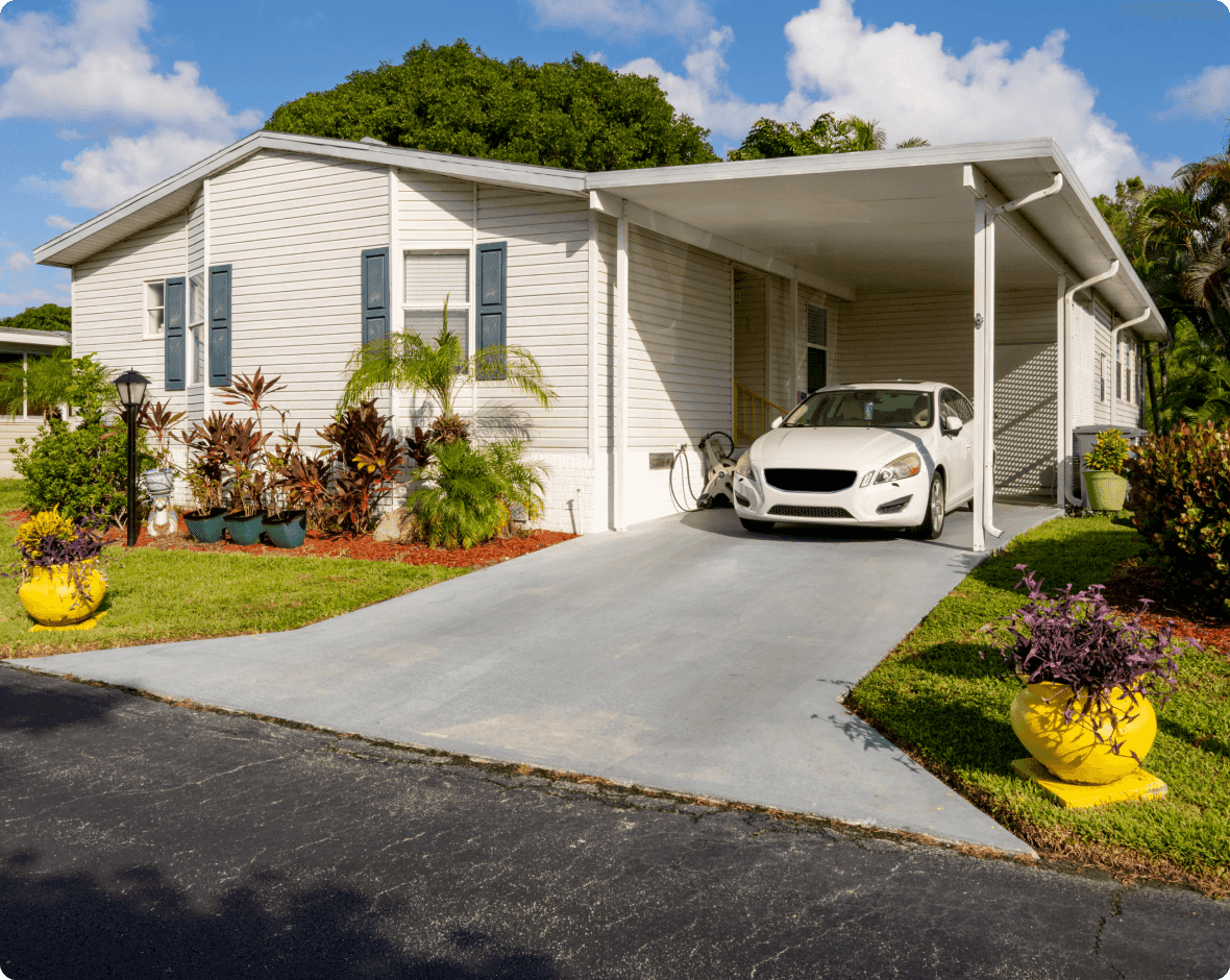 a white car parked in front of a house