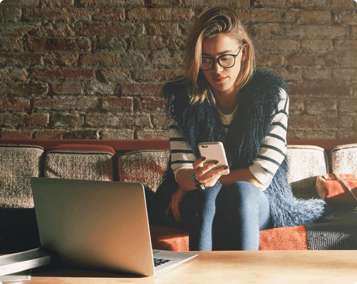 Rachel Duncan sitting at a table with a laptop and a phone