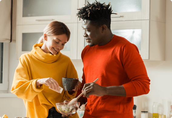 a man and woman holding a bowl of food
