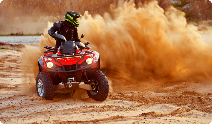 Rider racing in a red ATV